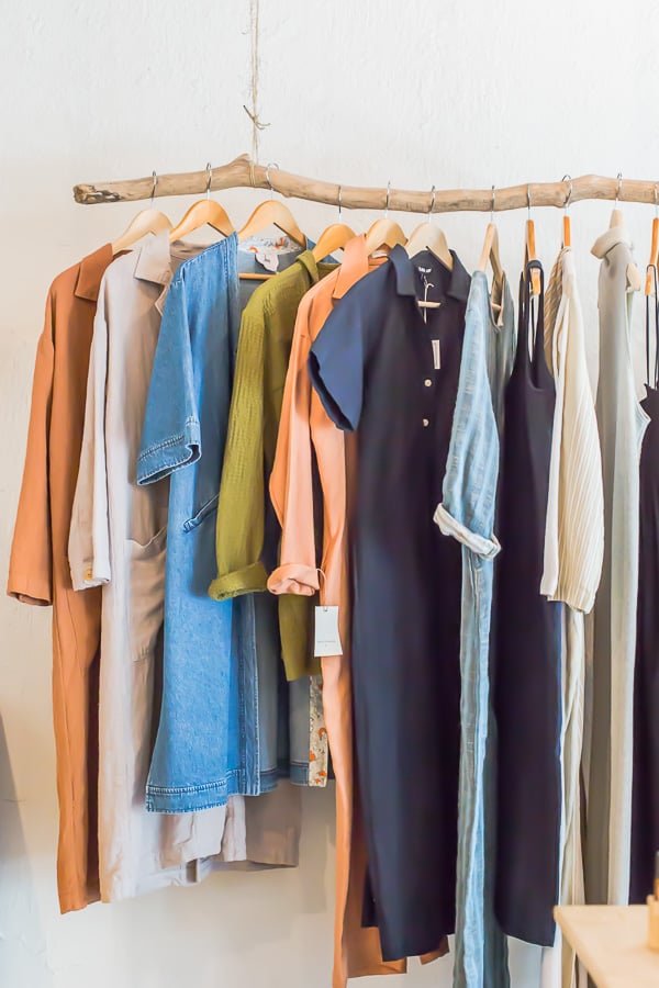 Hanging clothing rack idea - all you need is a stripped branch and some rope.