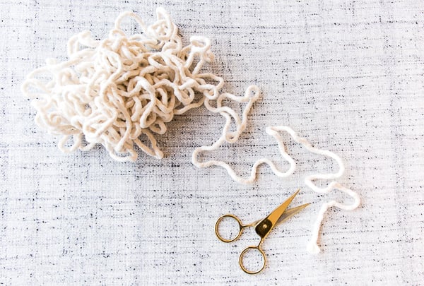 bundled up cotton piping with scissors on light grey tablecloth