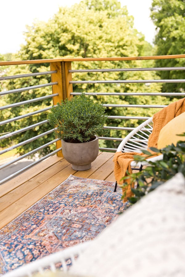 A balcony makeover perfect for summer entertaining or just reading a book. Click through for the full reveal and learn how to add privacy outdoors on a budget. #summer #outdoorspace #modernoutdoorspace