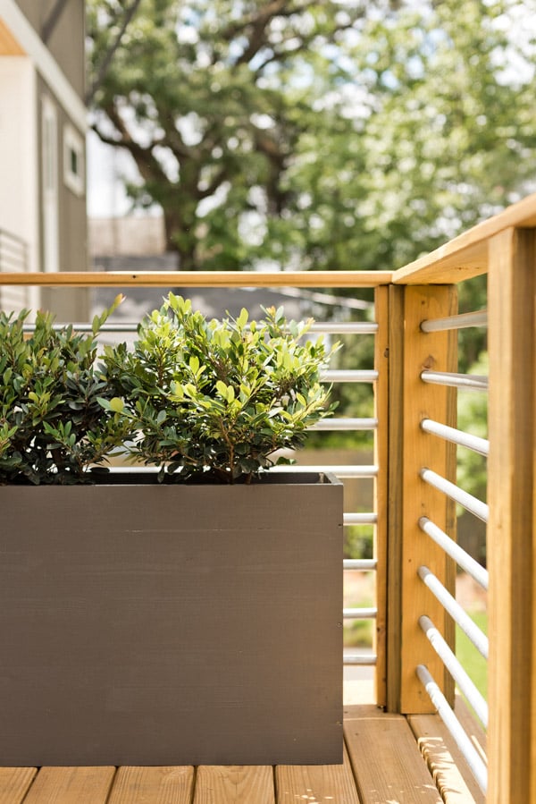 A balcony makeover perfect for summer entertaining or just reading a book. Click through for the full reveal and learn how to add privacy outdoors on a budget. #summer #outdoorspace #modernoutdoorspace