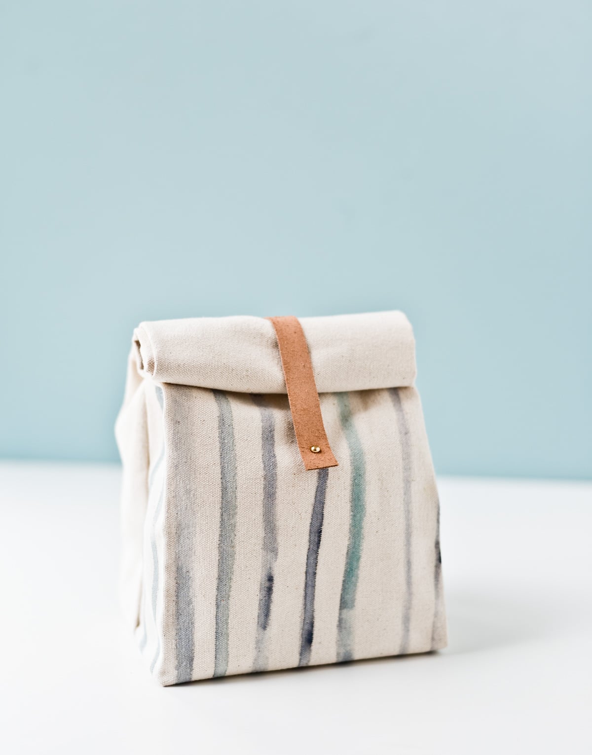 striped canvas punchbag with leather strap