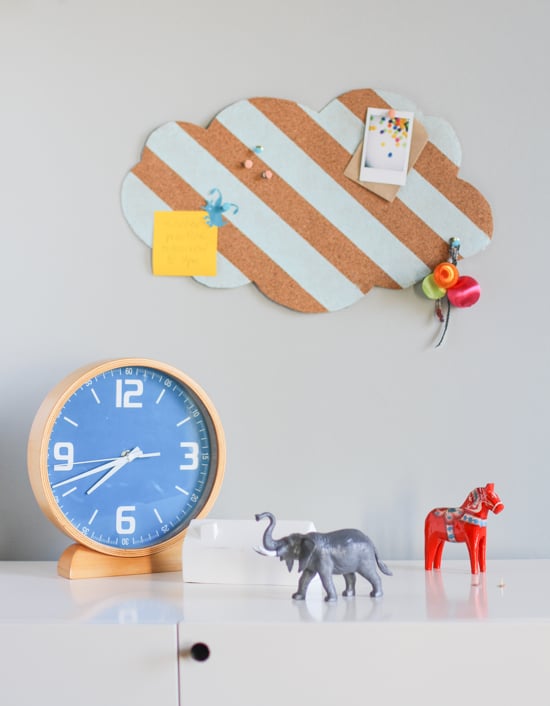 cloud shaped cork board with painted stripes, hanging on wall in kids room