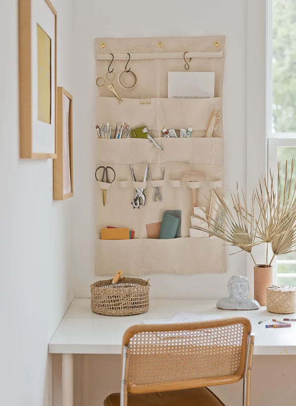 hanging wall organizer with art supplies in a minimal modern home office