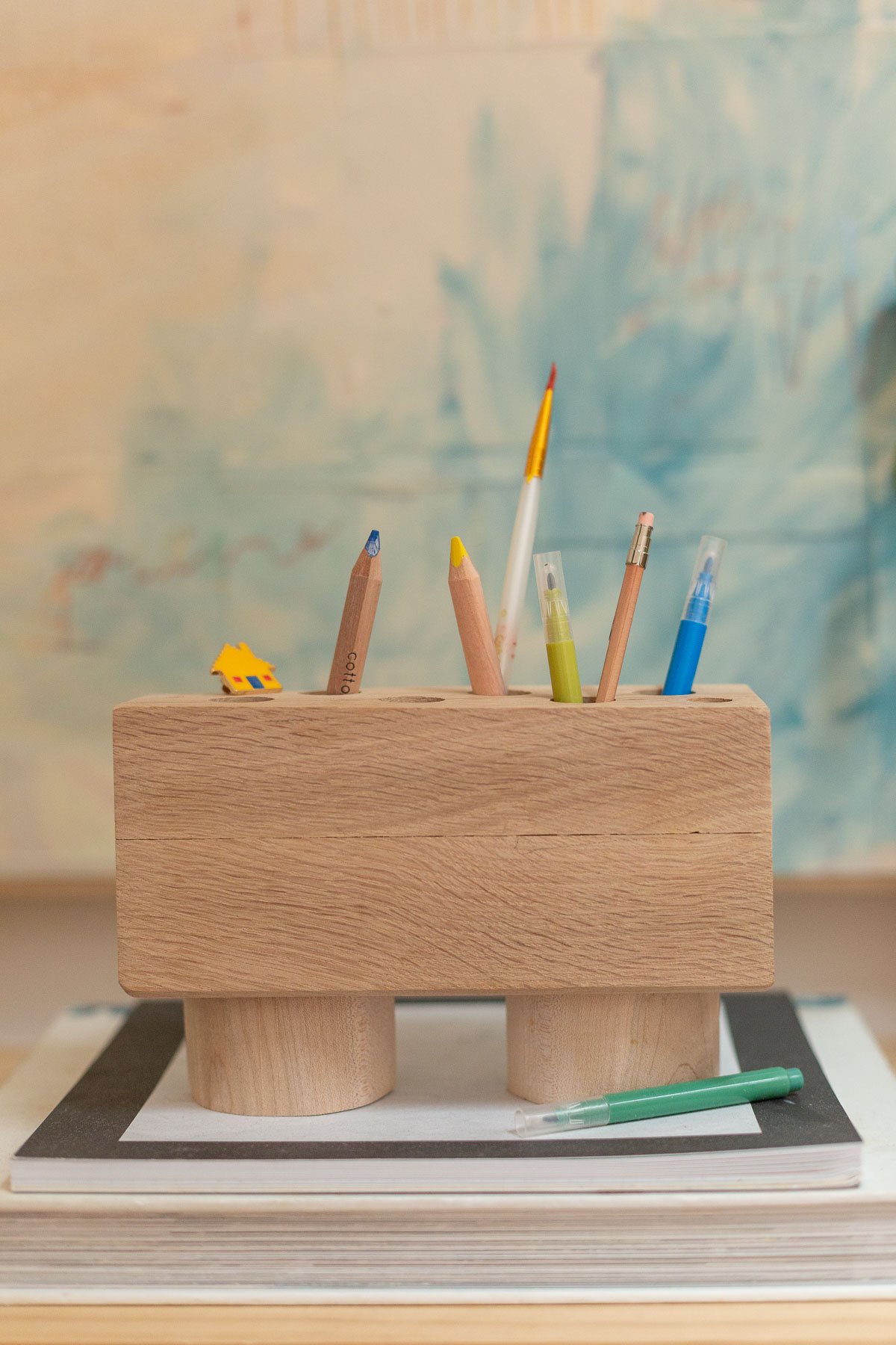minimal wood pencil holder sitting on artful desk