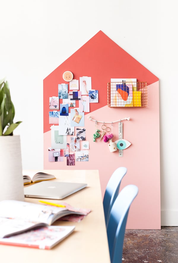 pink and red giant bulletin board with shelving and hooks for organization 