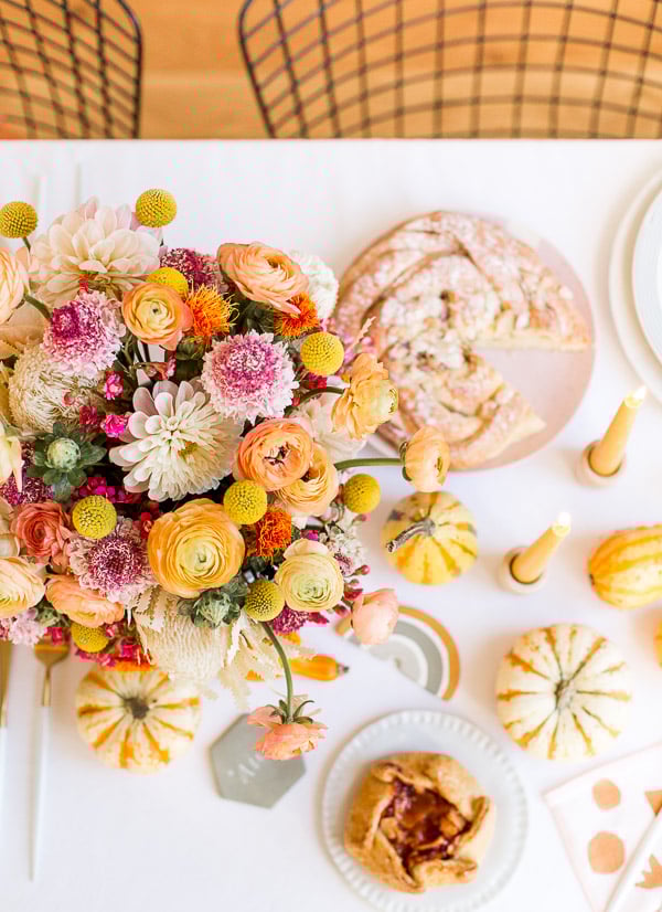 colorful thanksgiving tablescape decor with flowers and pumpkins 