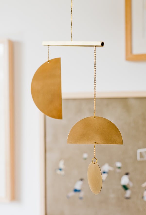 A brass mobile for a little boy's gender neutral nursery.