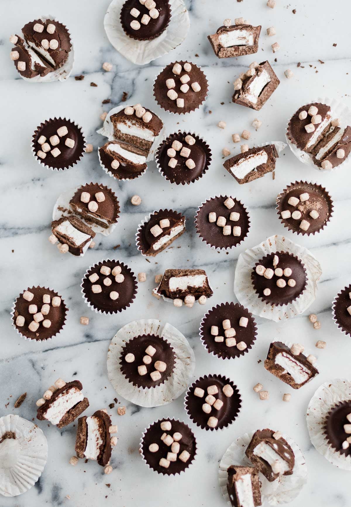 chocolate candy cups with marshmallow on a marble counter