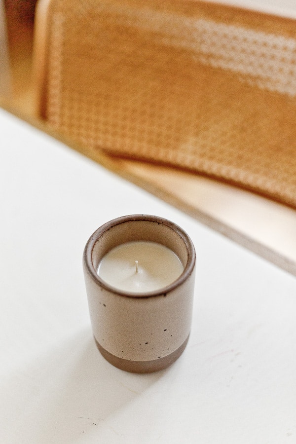 Homemade candle in East Fork Pottery container on dining room table.