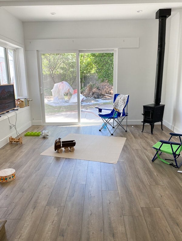Before photo of bedroom / tv room with sliding doors that lead outside.
