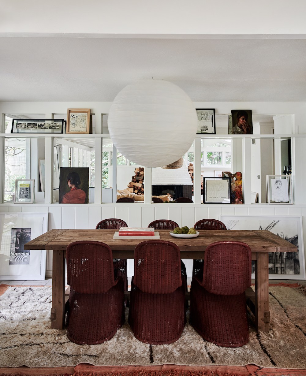 eclectic dining room with rustic table and dark red painted chairs