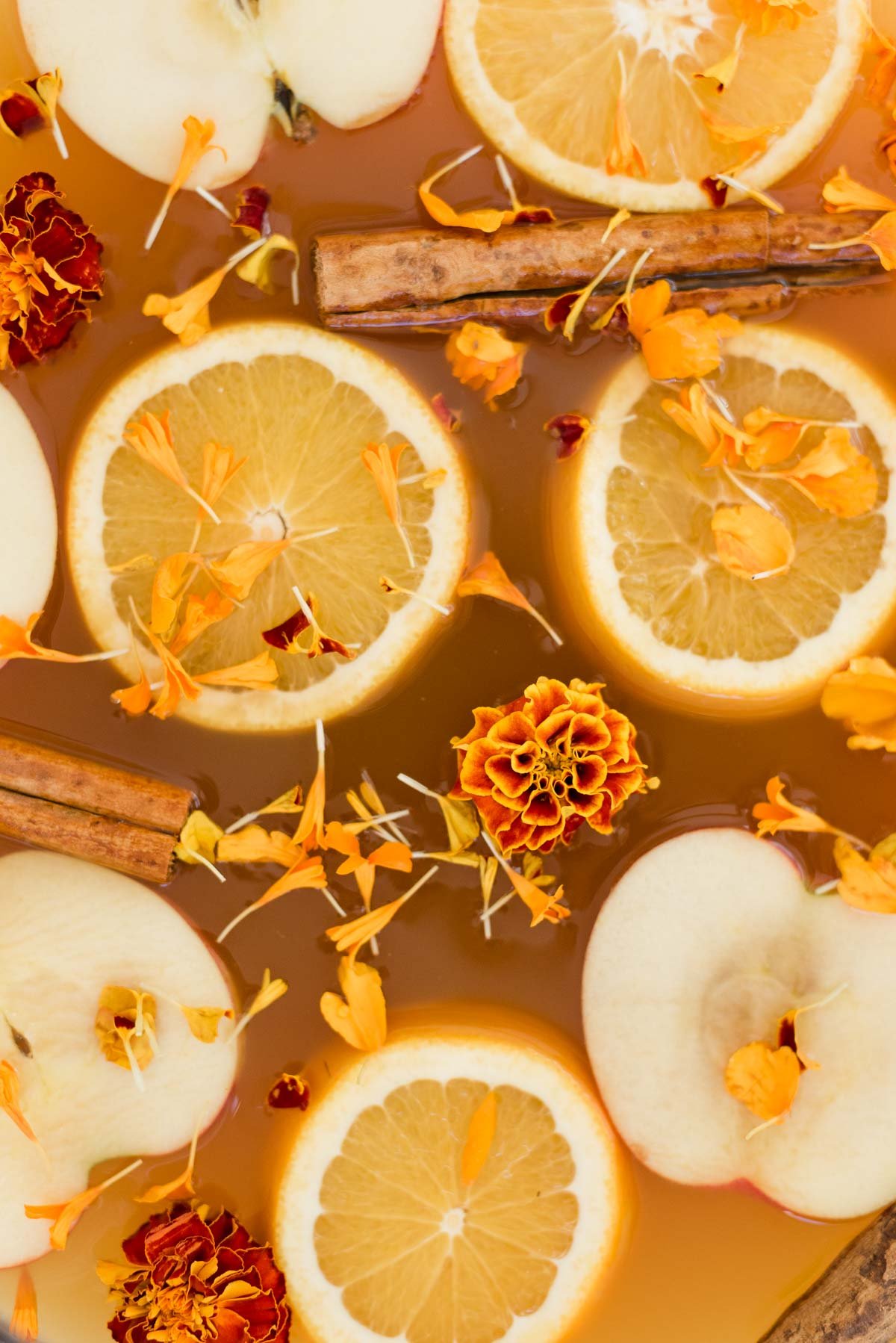 Apple and orange slices for spiked cider in punch bowl (batch cocktails for the holidays)