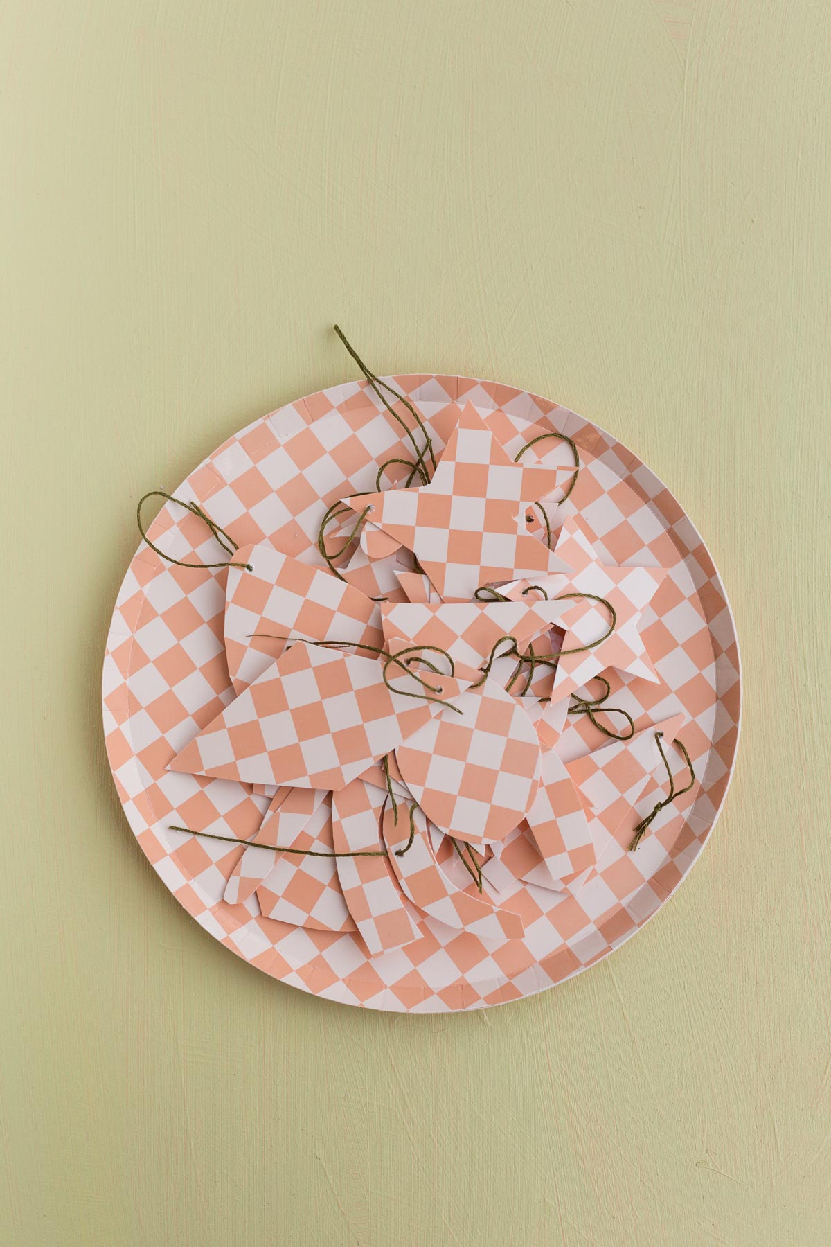 completed diy ornaments sitting on top of checkered paper plate