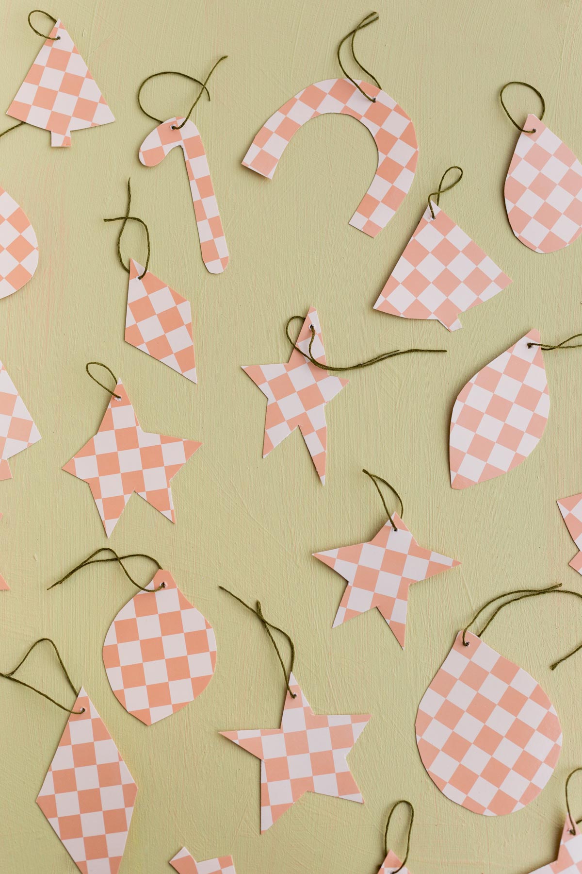 pink checkered ornaments that were made from paper plates