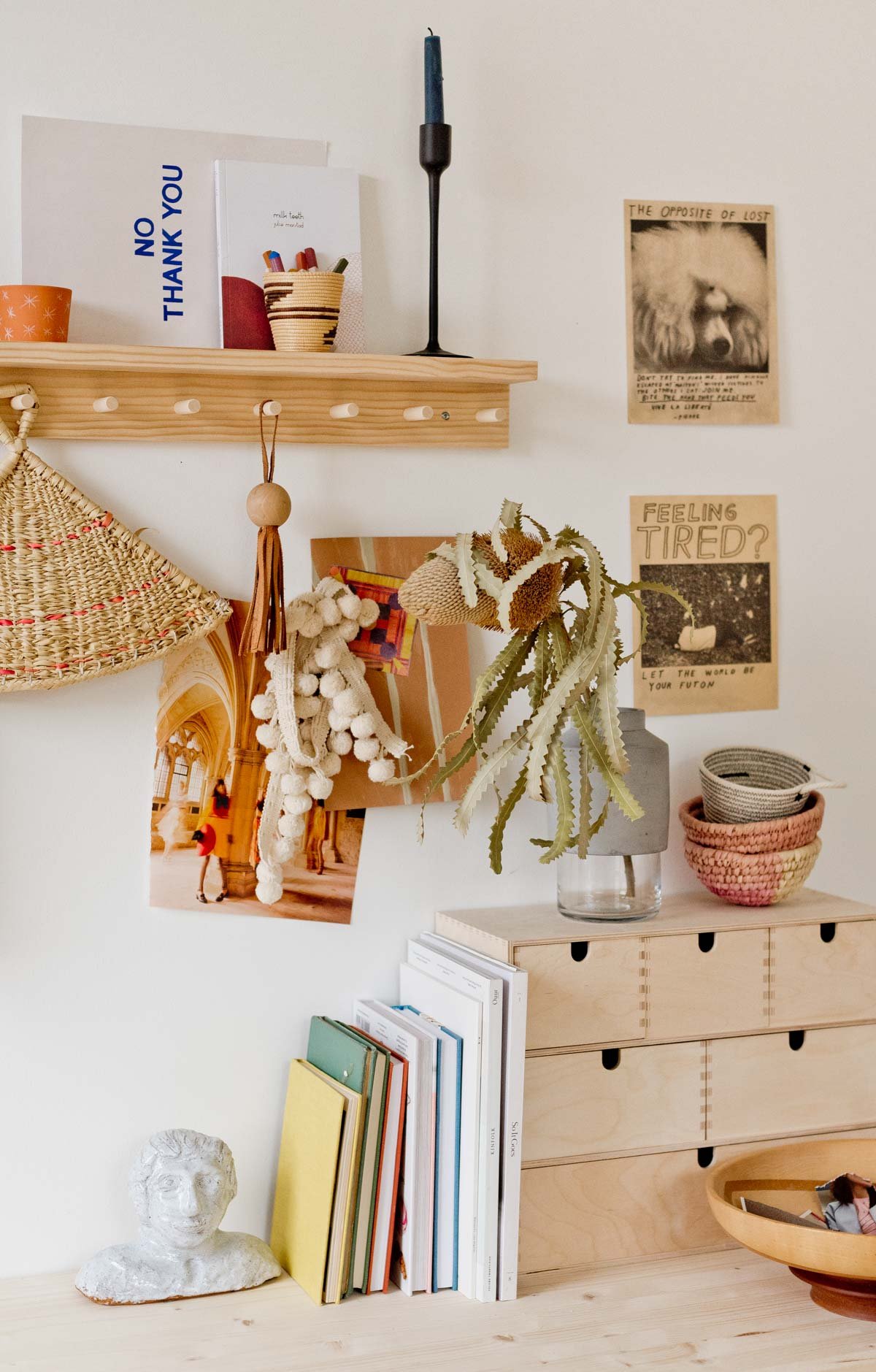 earthy minimal workspace with wood desk and hanging home decor accessories