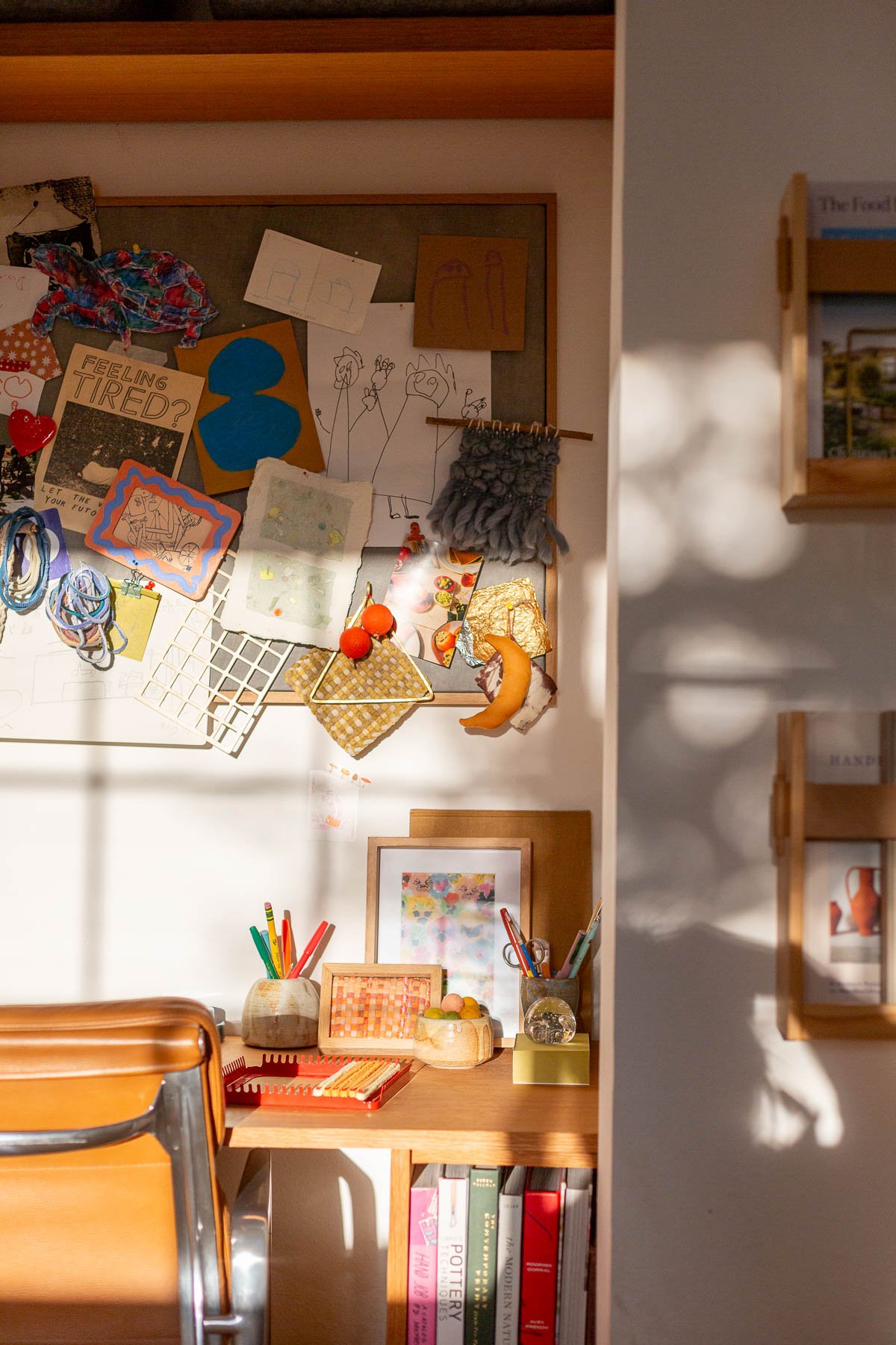 artsy cluttered desk space in a closet