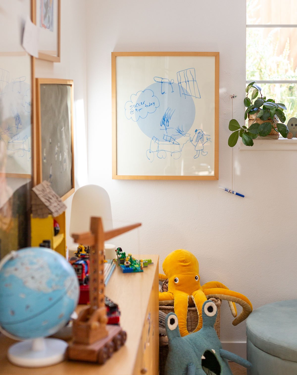 kids room with modern artwork and colorful stuffed animals