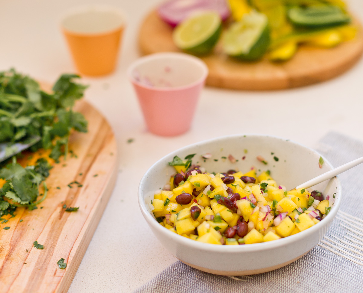 closeup of mango salsa in small bowl on countertop