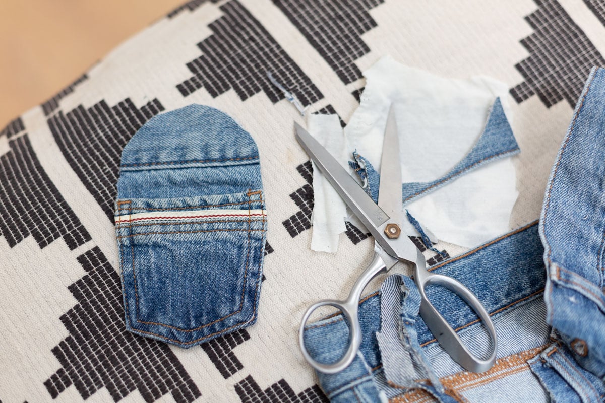cutting small pocket from denim jeans to make a small purse for kids