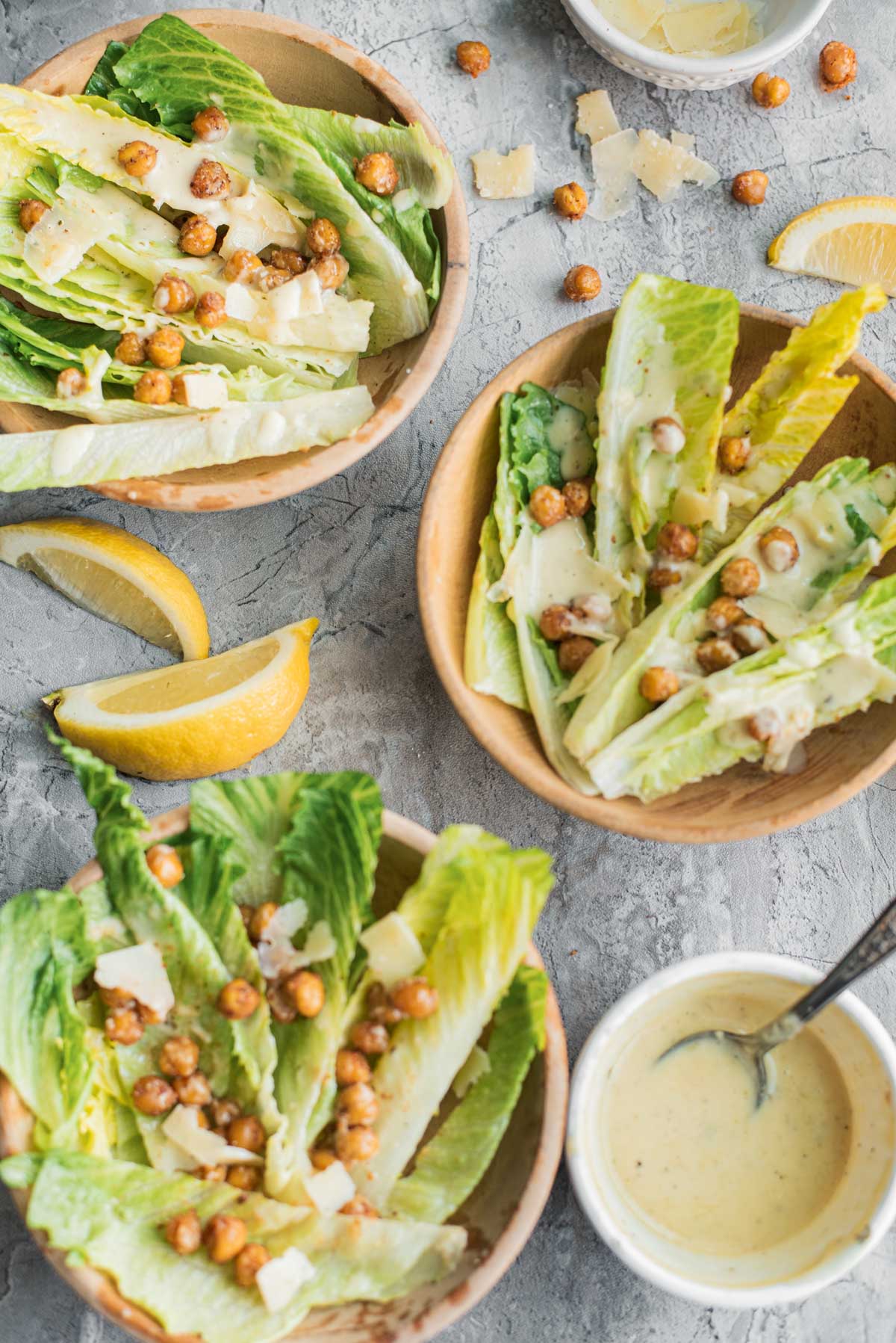 small bowls of crispy chickpea salad with homemade dressing and lemon slices