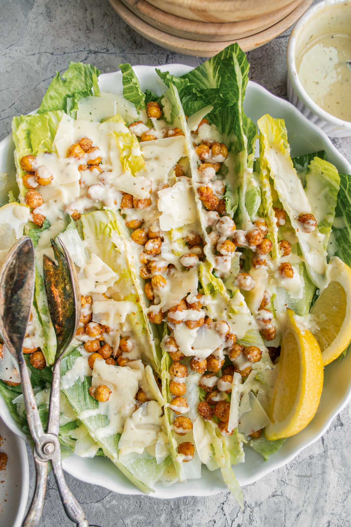 Drizzled dressing on top of crispy chickpeas and romaine lettuce