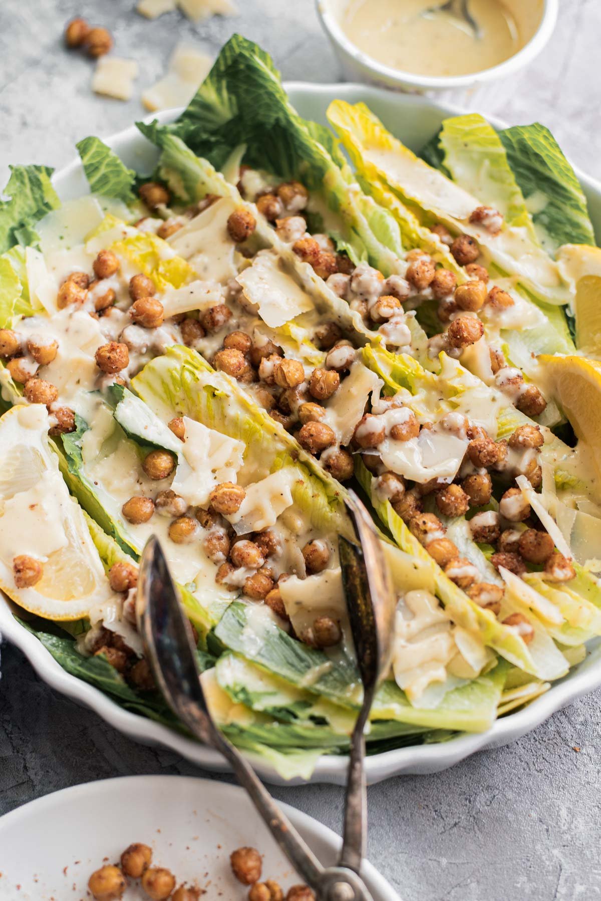 roasted chickpea salad with serving tongs