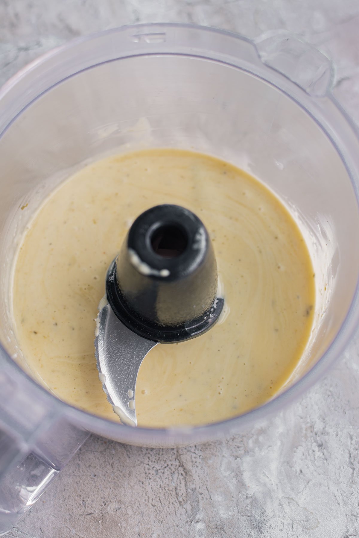 homemade dressing being blended in a food processor