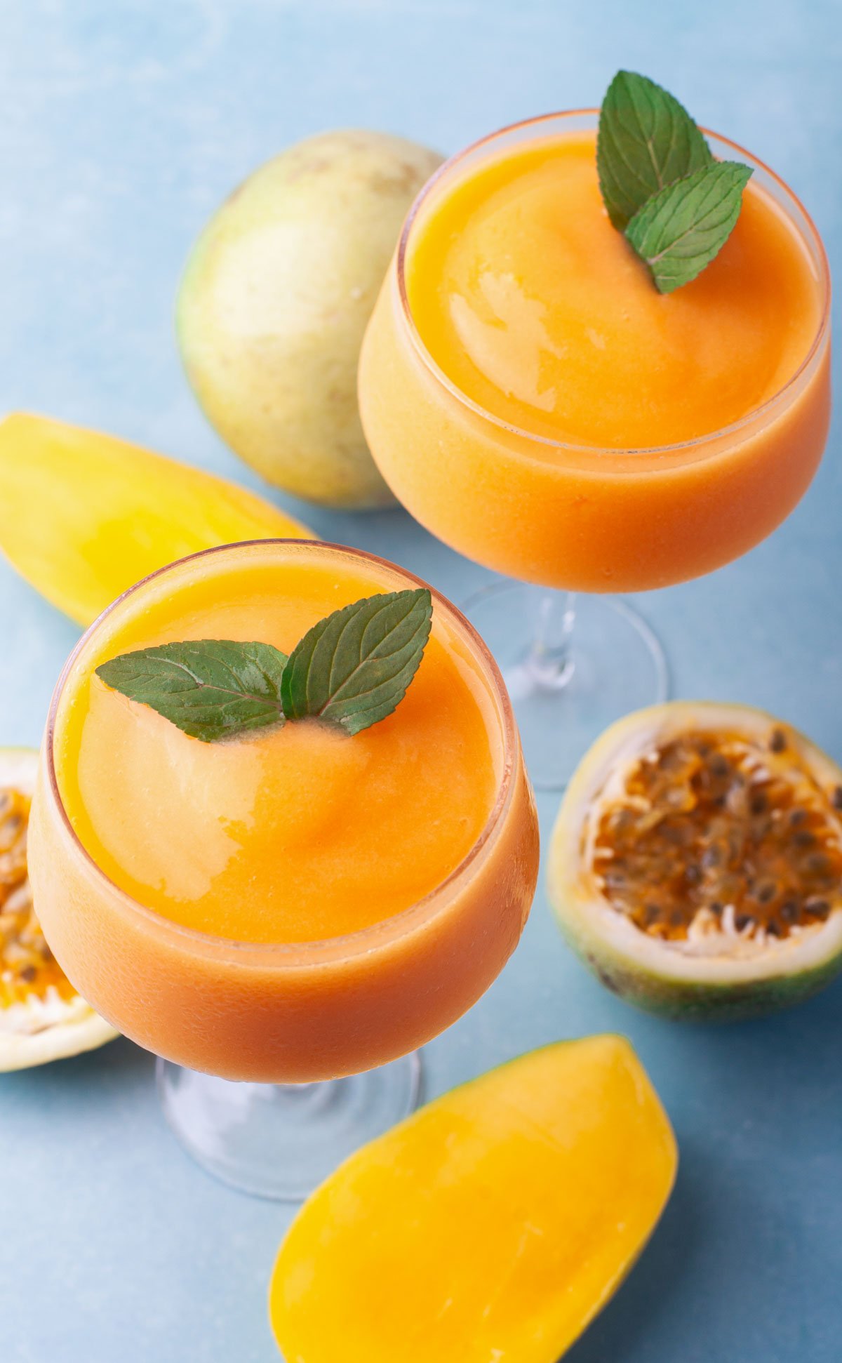 closeup overhead orange frozen cocktail on blue counter for summer