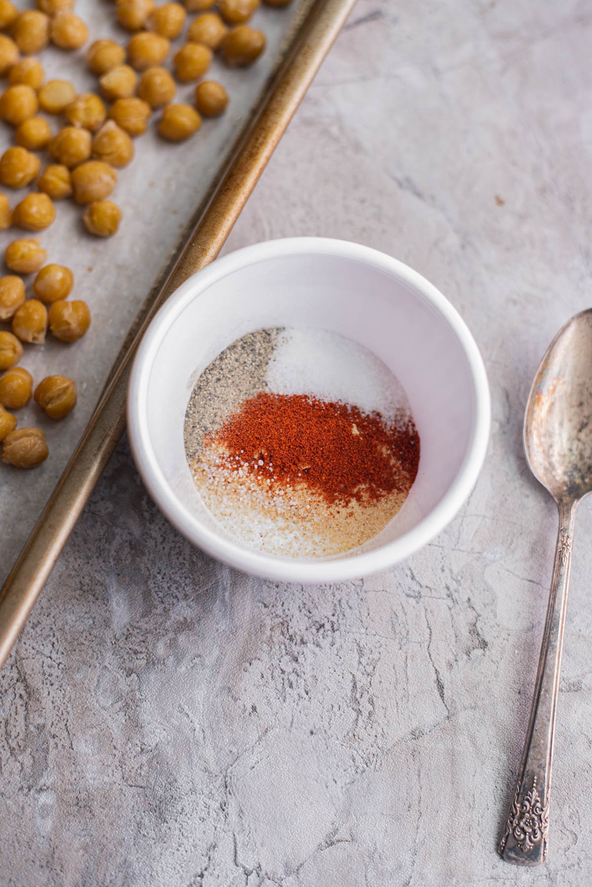 mixing spices together in a small bowl to make roasted chickpeas