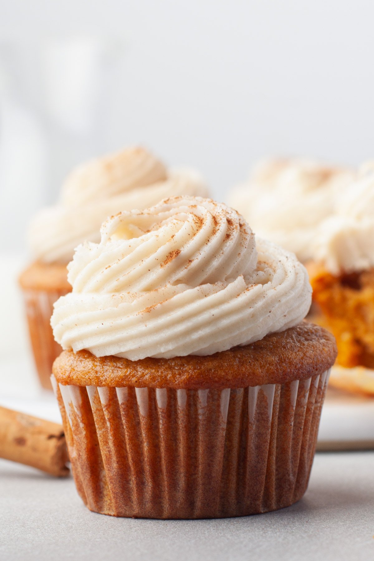 closeup pumpkin cream cheese cupcake with swirled frosting