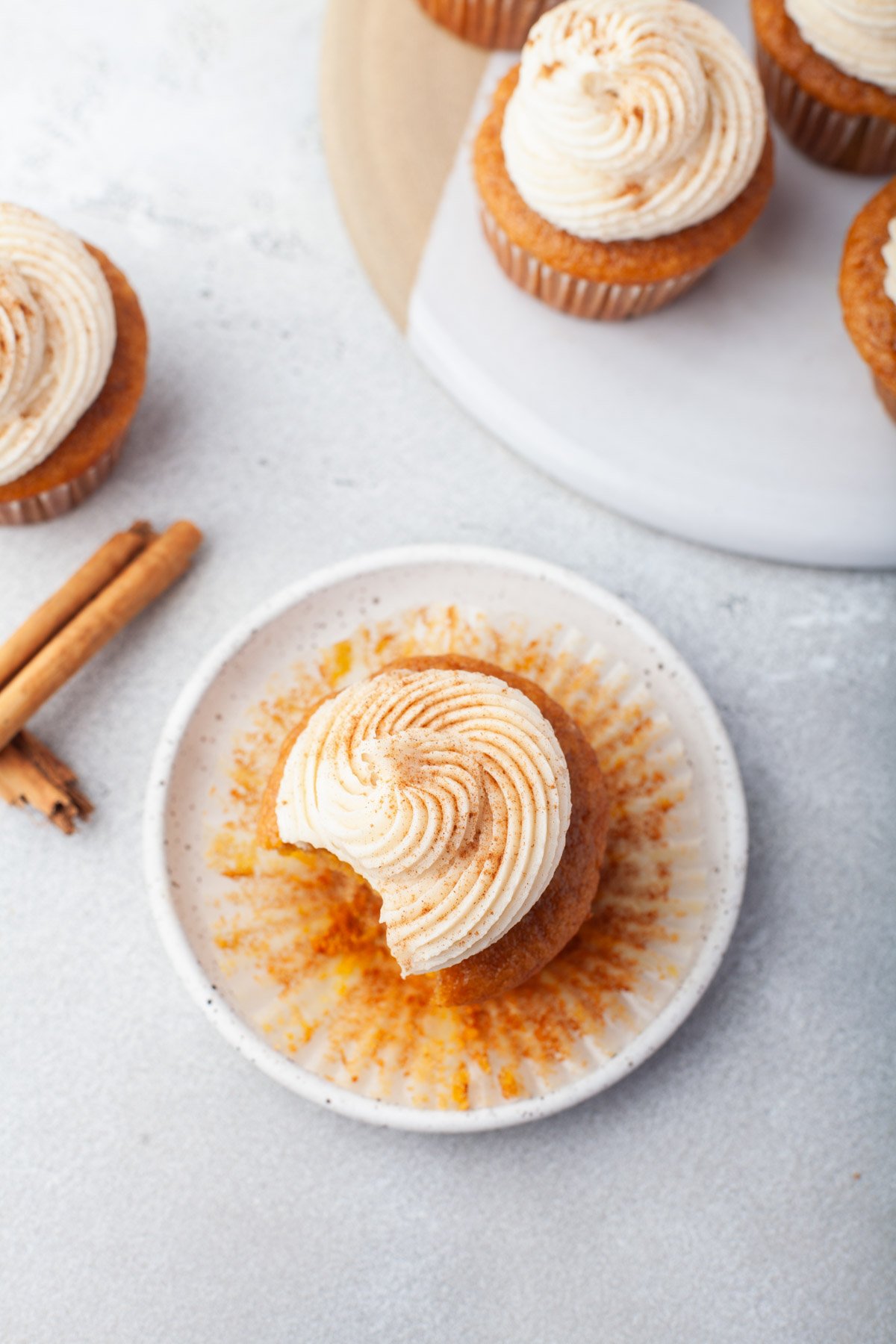 pumpkin cupcake with bite out of it on small plates 