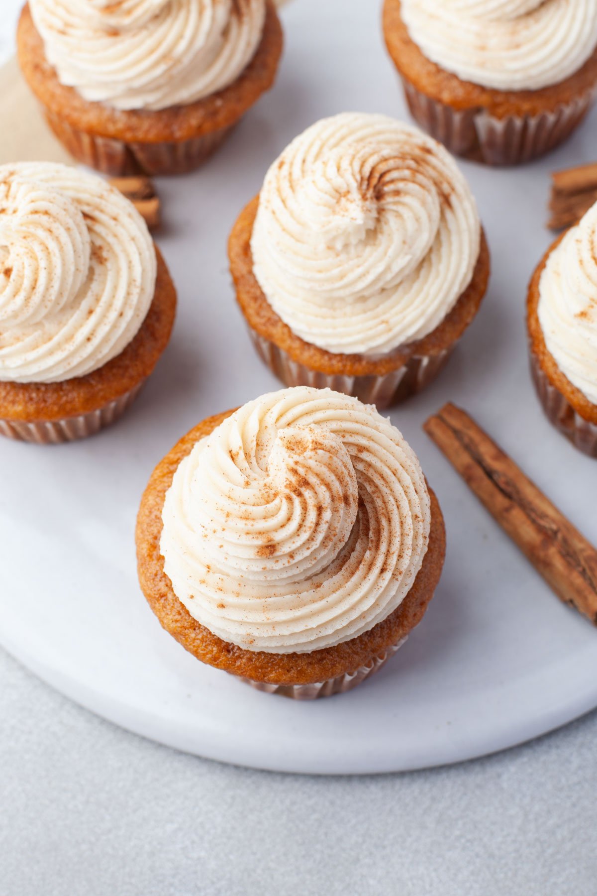 overhead of pumpkin cream cheese cupcakes on large platter