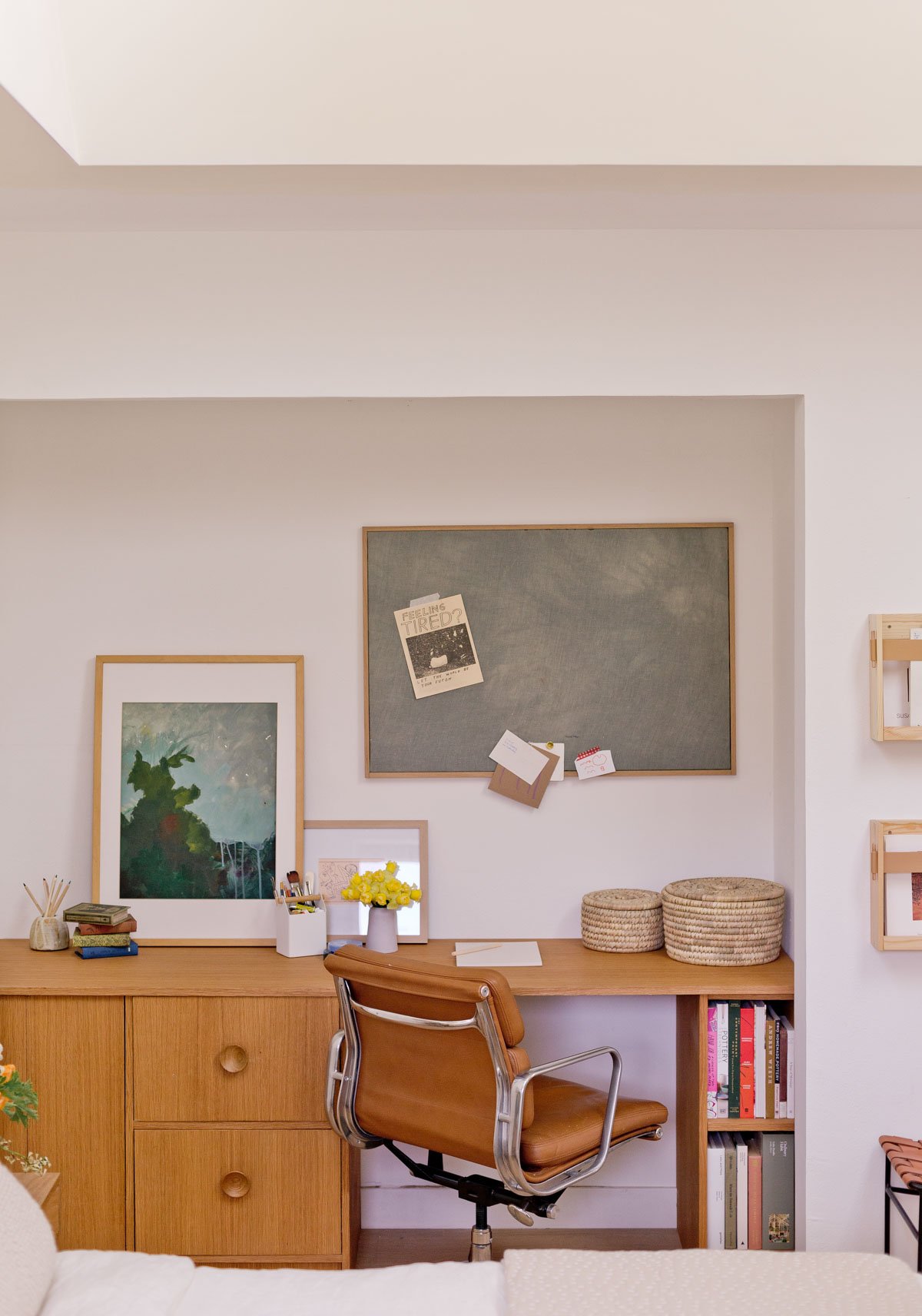 wood desk in minimal modern style with art on the walls and minimal styling