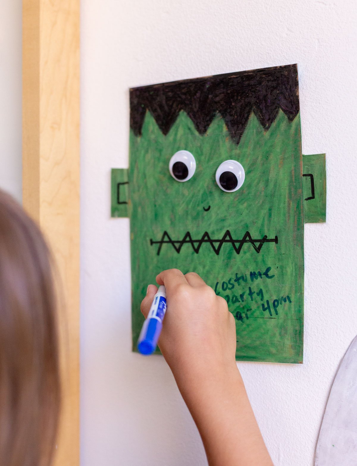 child drawing on halloween dry erase board