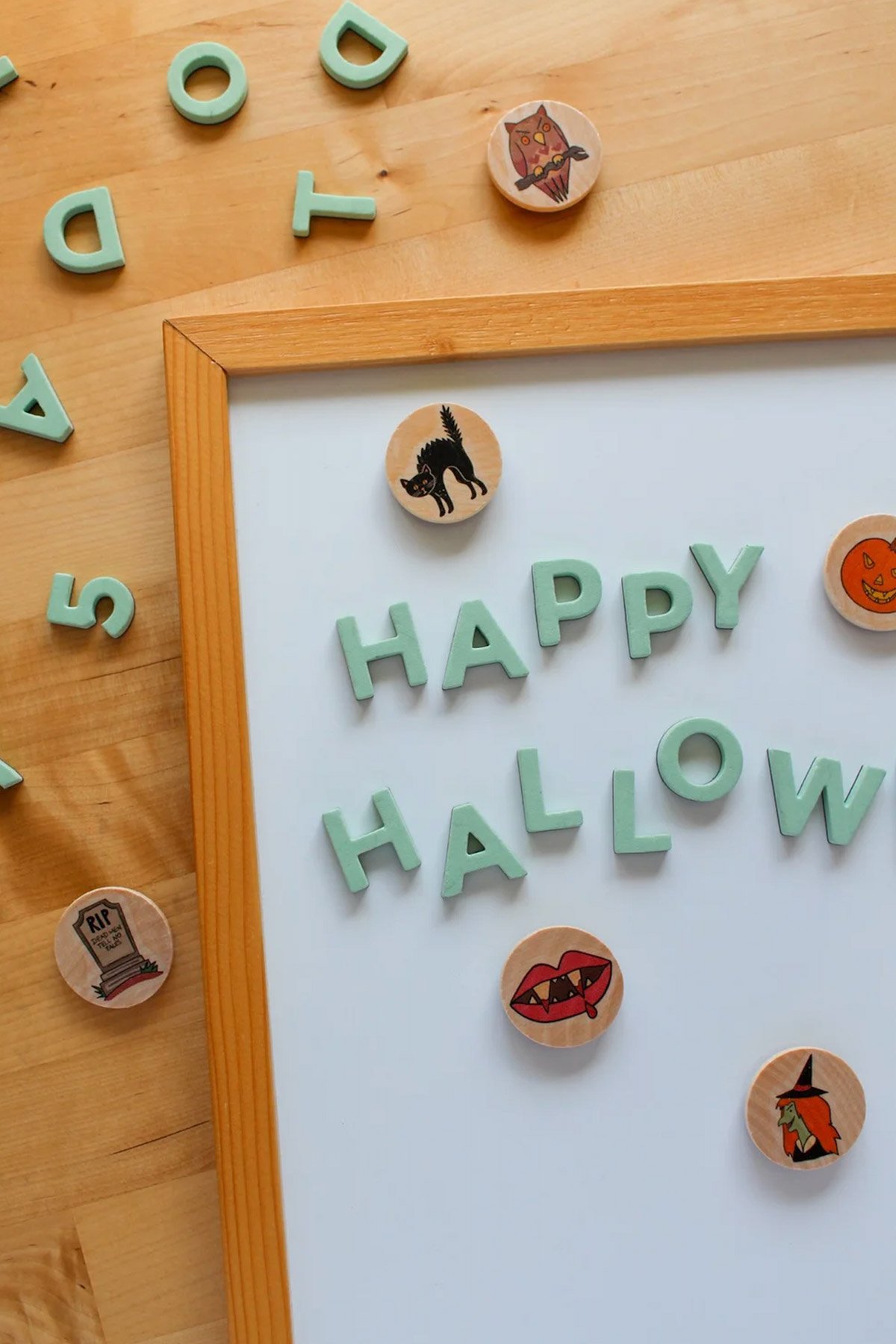 wooden halloween magnets on a white board