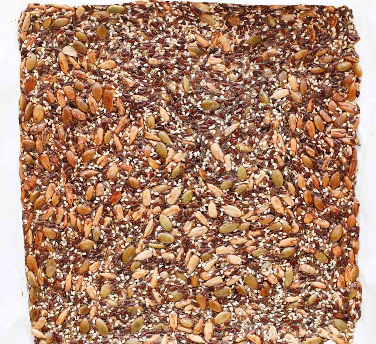 seed crackers after they've been baked, but have not been broken apart into individual crackers yet