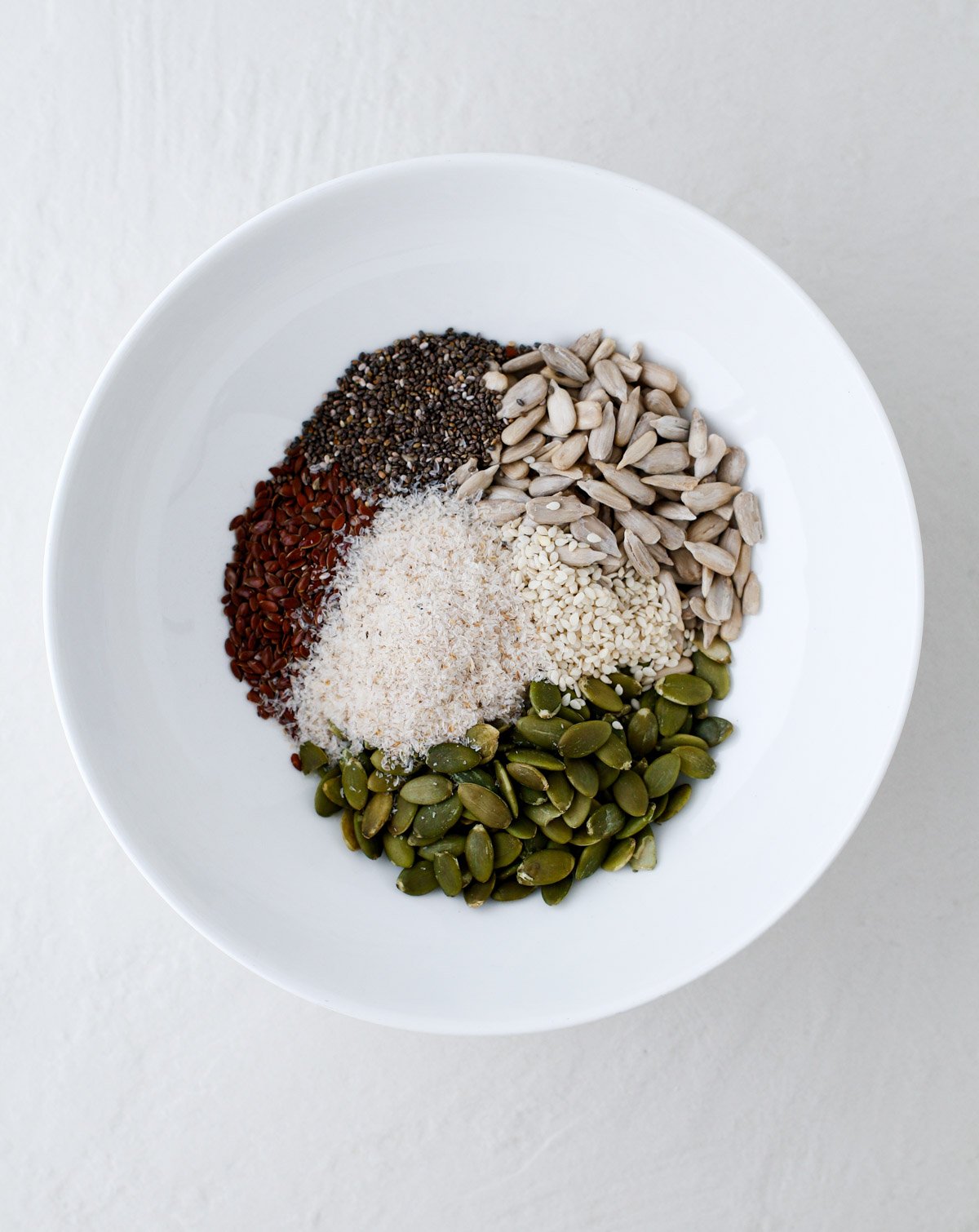 seeds and other ingredients in a bowl, ready to be mixed