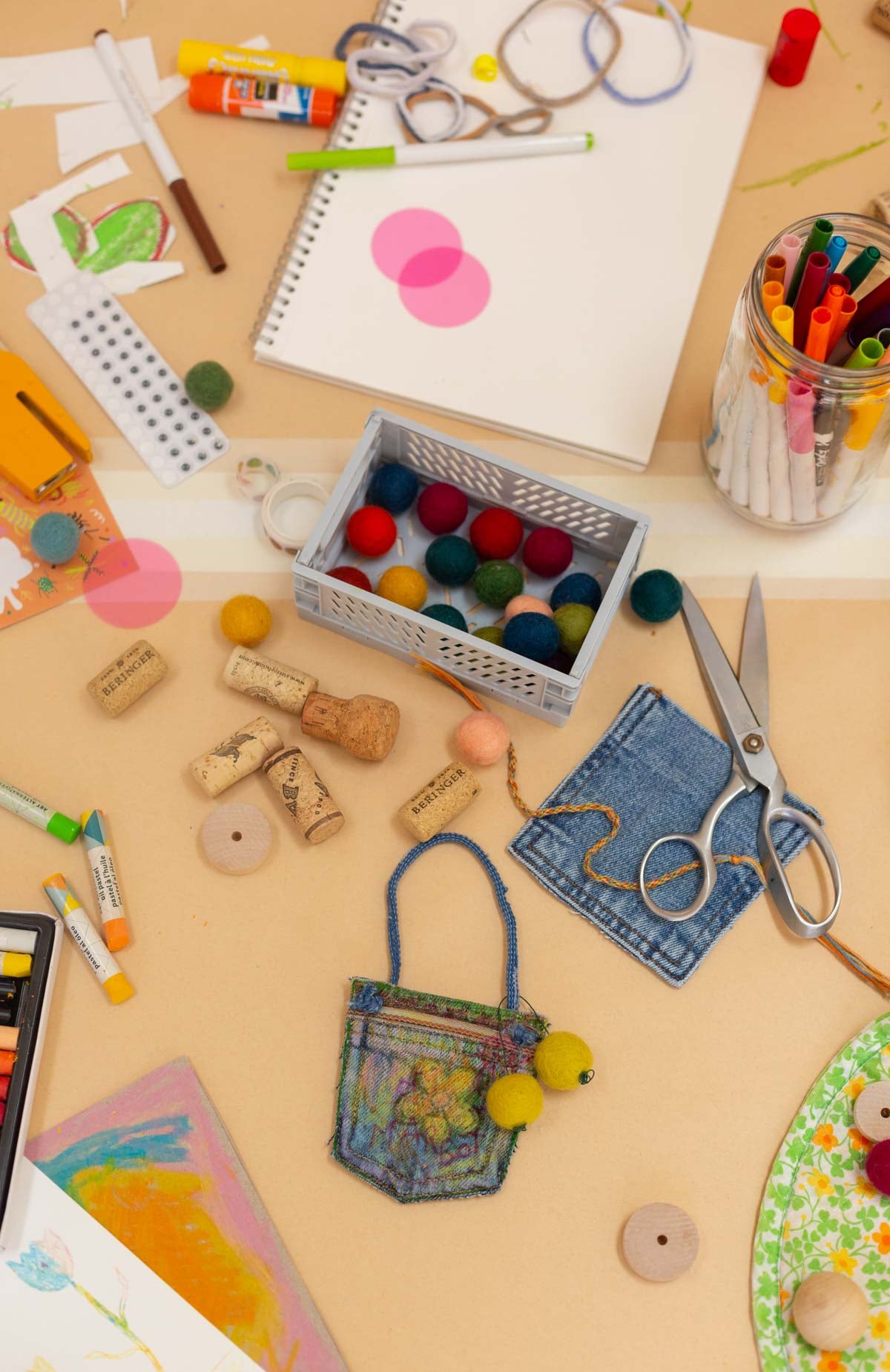 cluttered beige table filled with kids craft supplies
