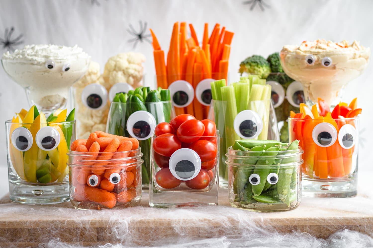veggies in clear jars with googly eyes for halloween party
