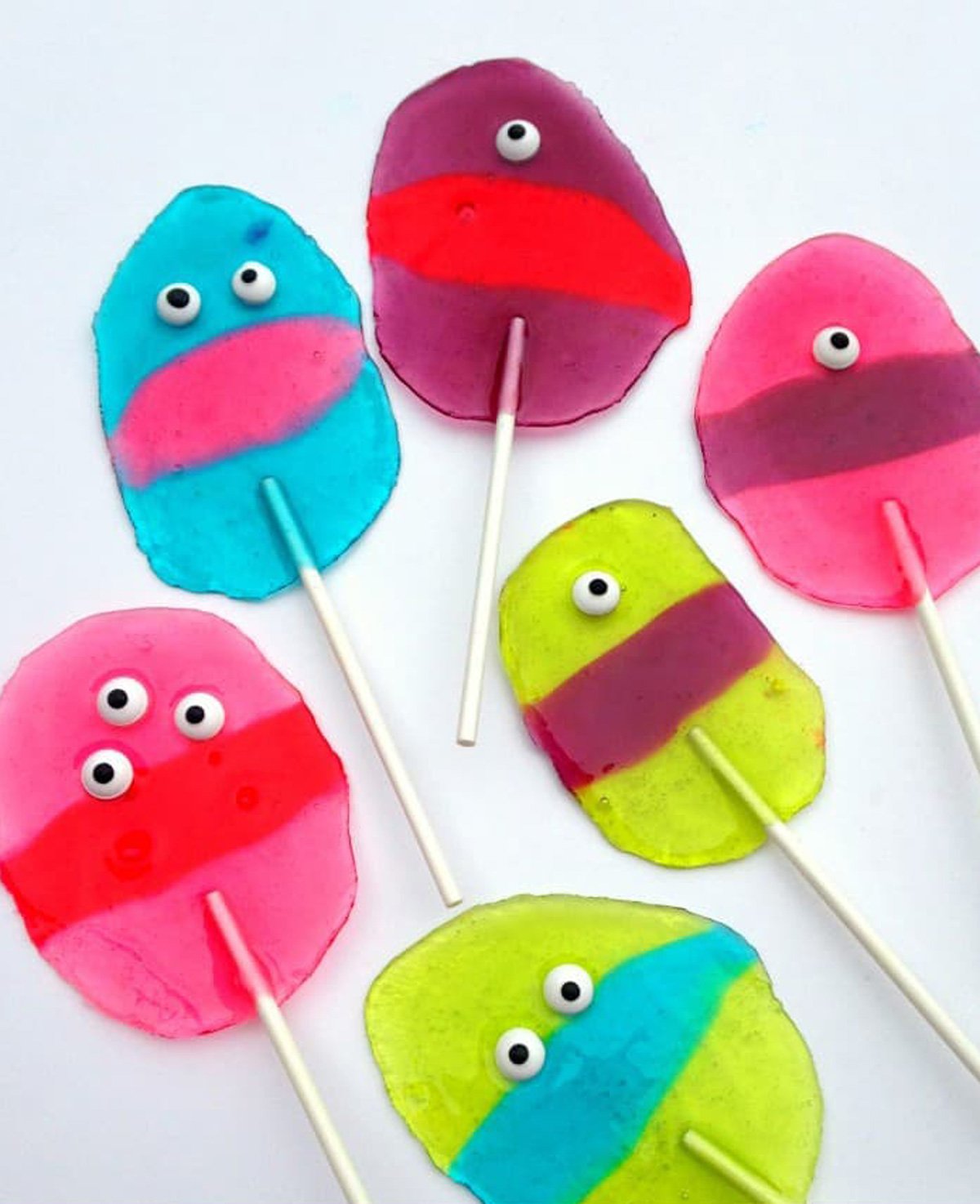 homamde halloween lollipops that look like colorful, cute monsters