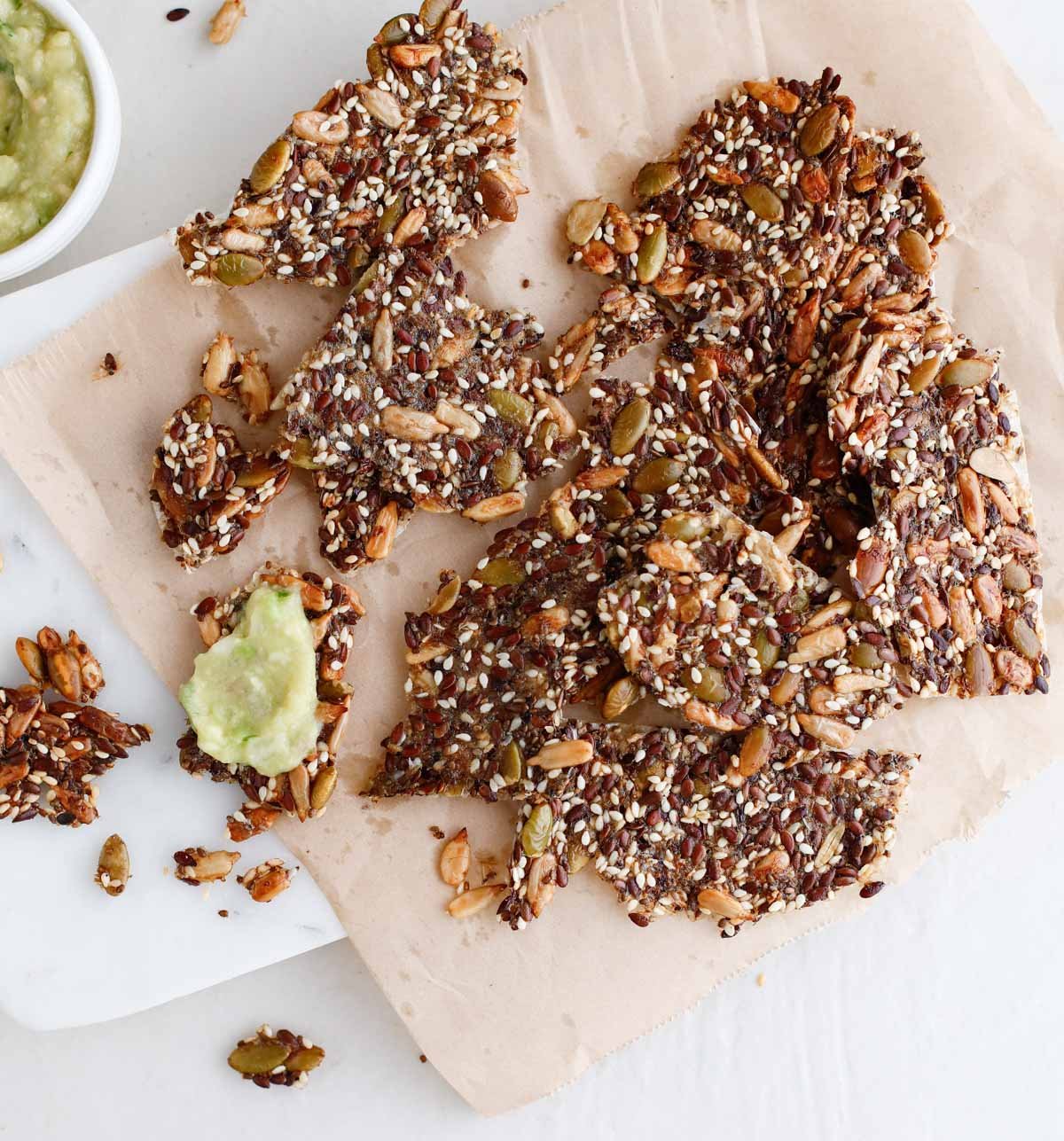 seed crackers on a cracker board with dips 