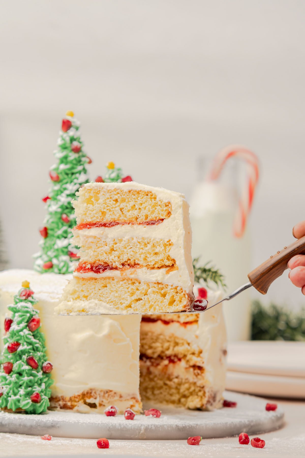 woman's hand holding a slice of cake on a spatula