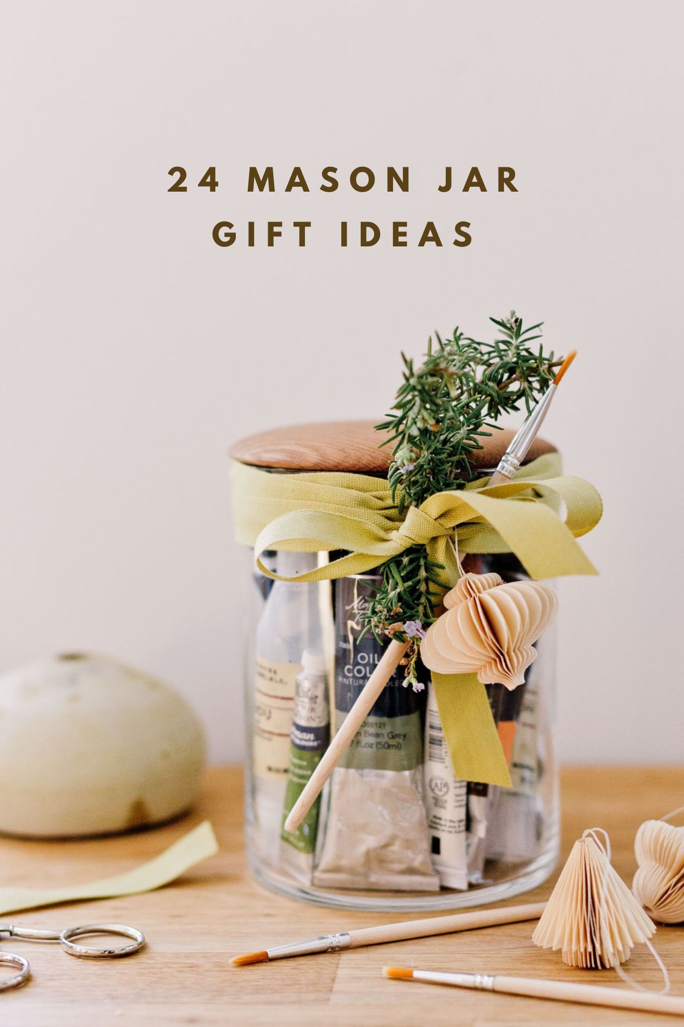 glass mason jar filled with art supplies and paint brushes for a creative holiday gift