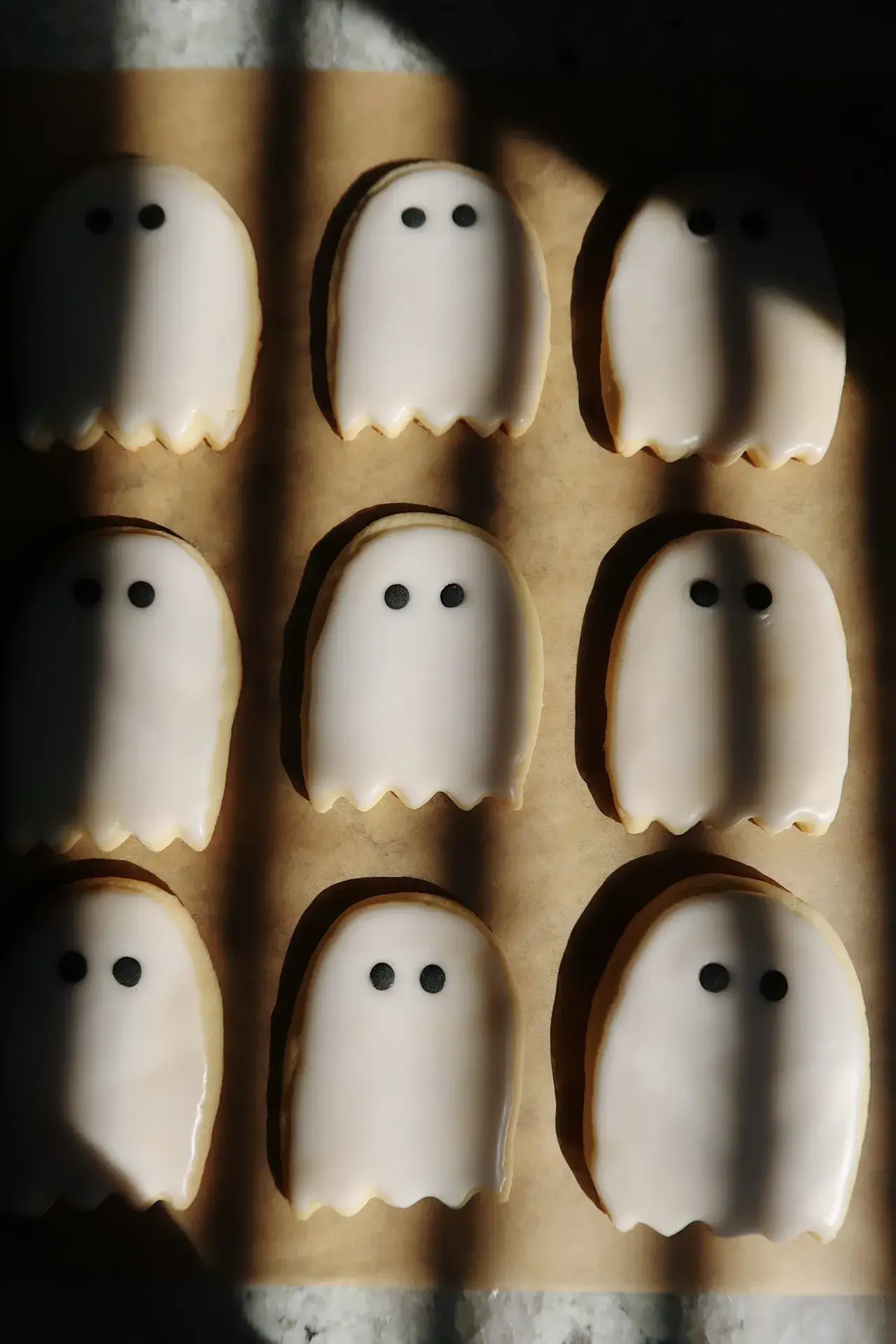 minimal ghost cookies in a shadowy kitchen
