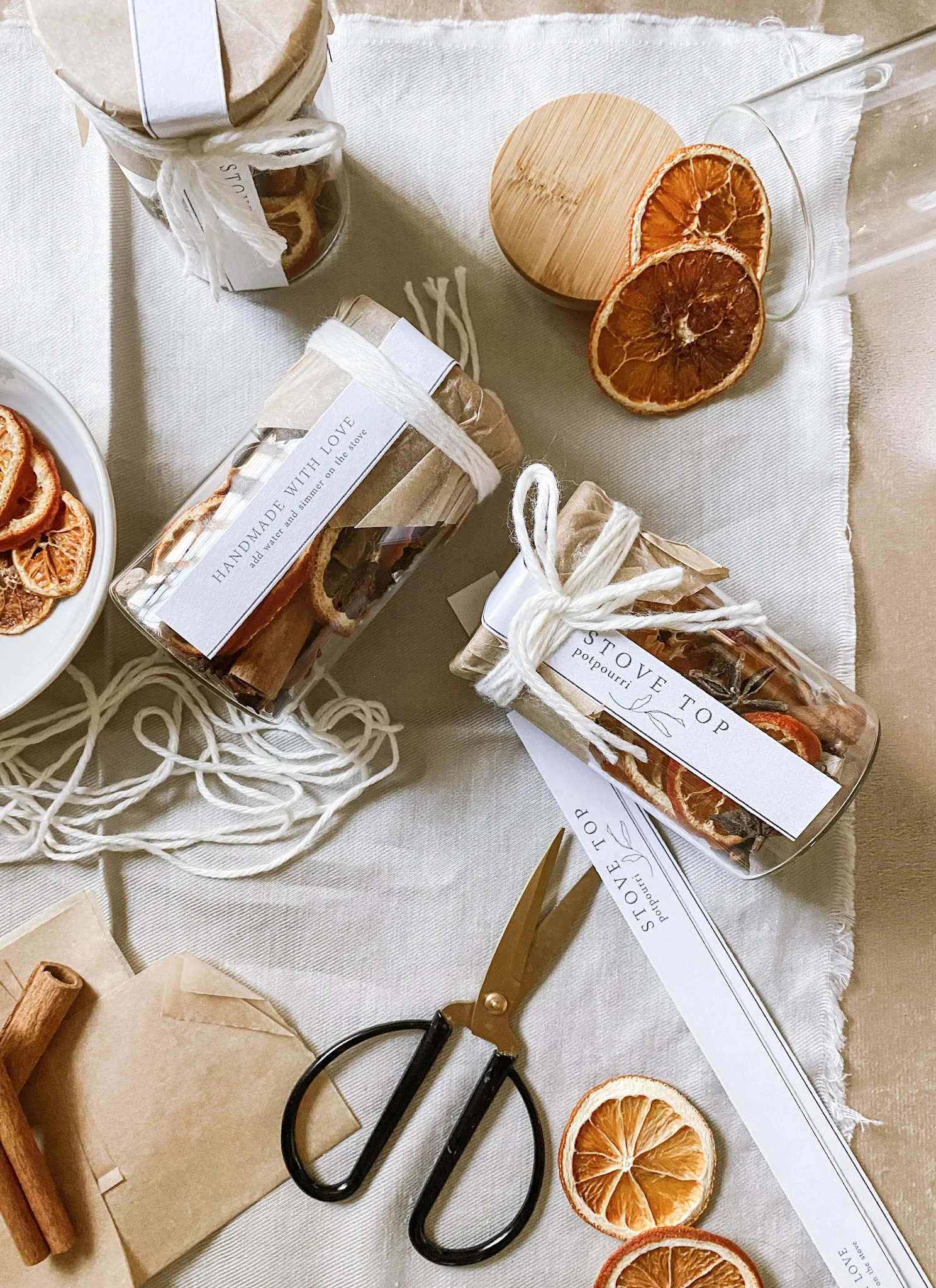 stove top potpourri being packaged in glass jars with twine and cute minimal tags