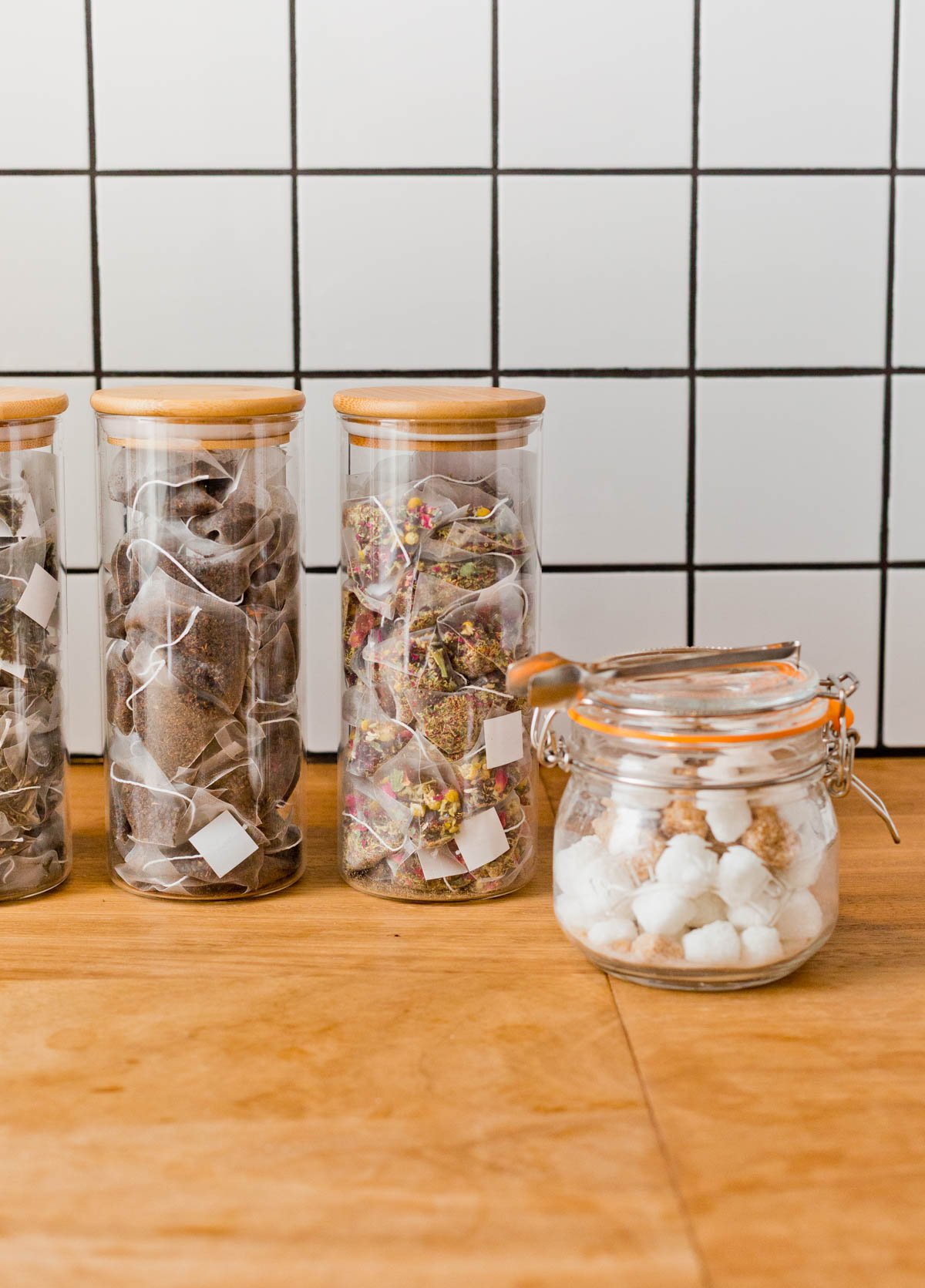 glass jars filled with tea bags and sugar cubes