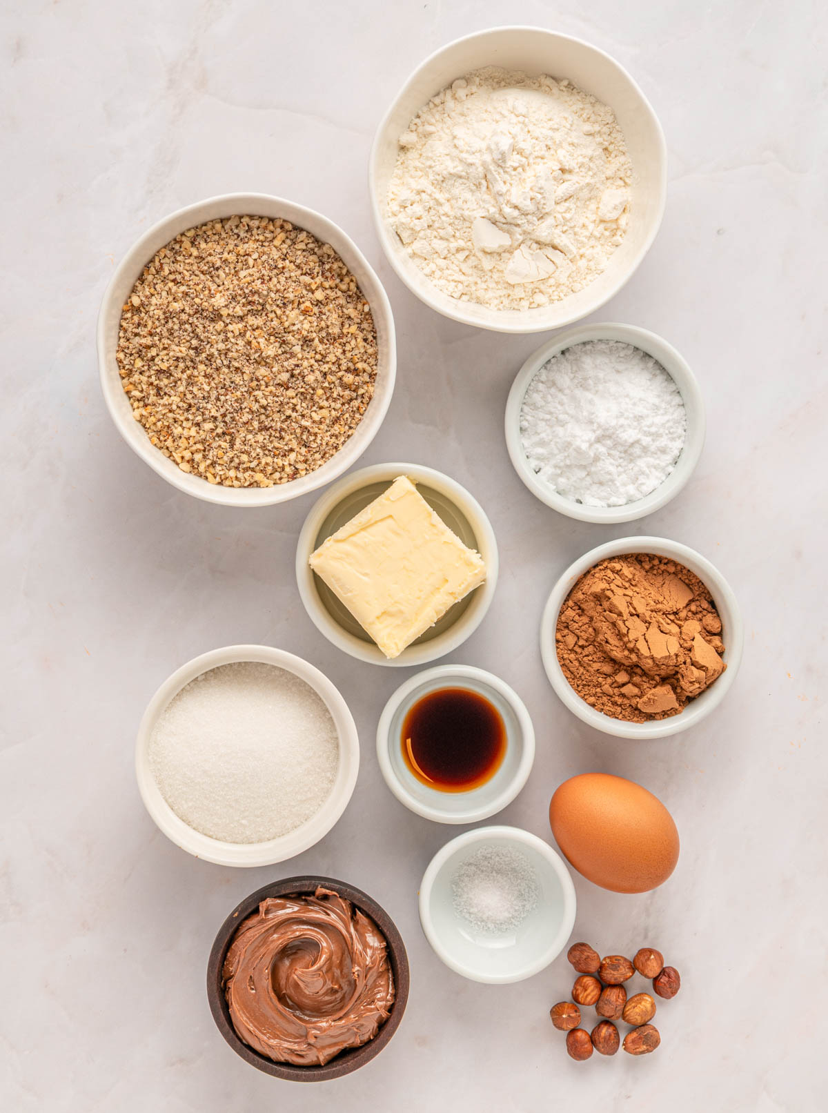 ingredients needed to make chocolate linzer cookie, all in individual bowls