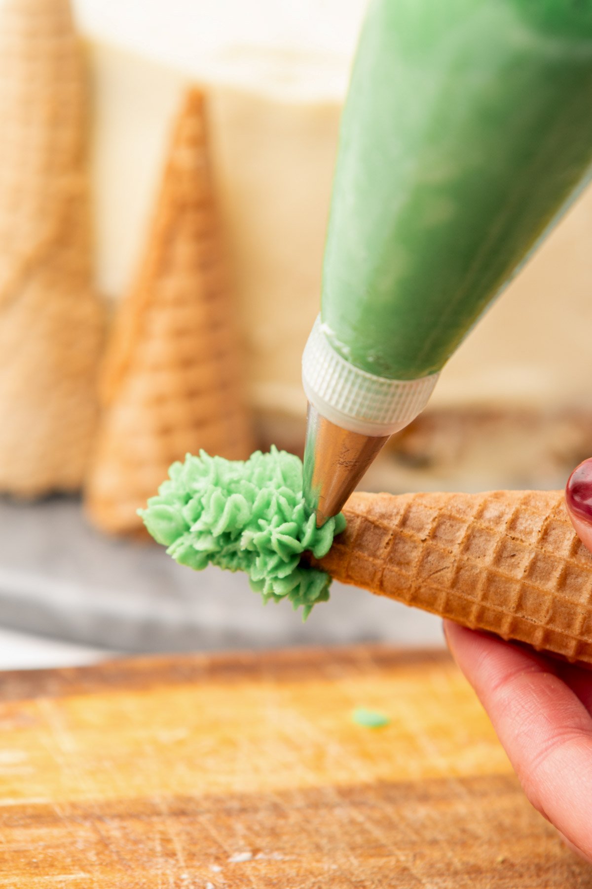 creating festive edible christmas trees with green buttercream icing and ice cream cones