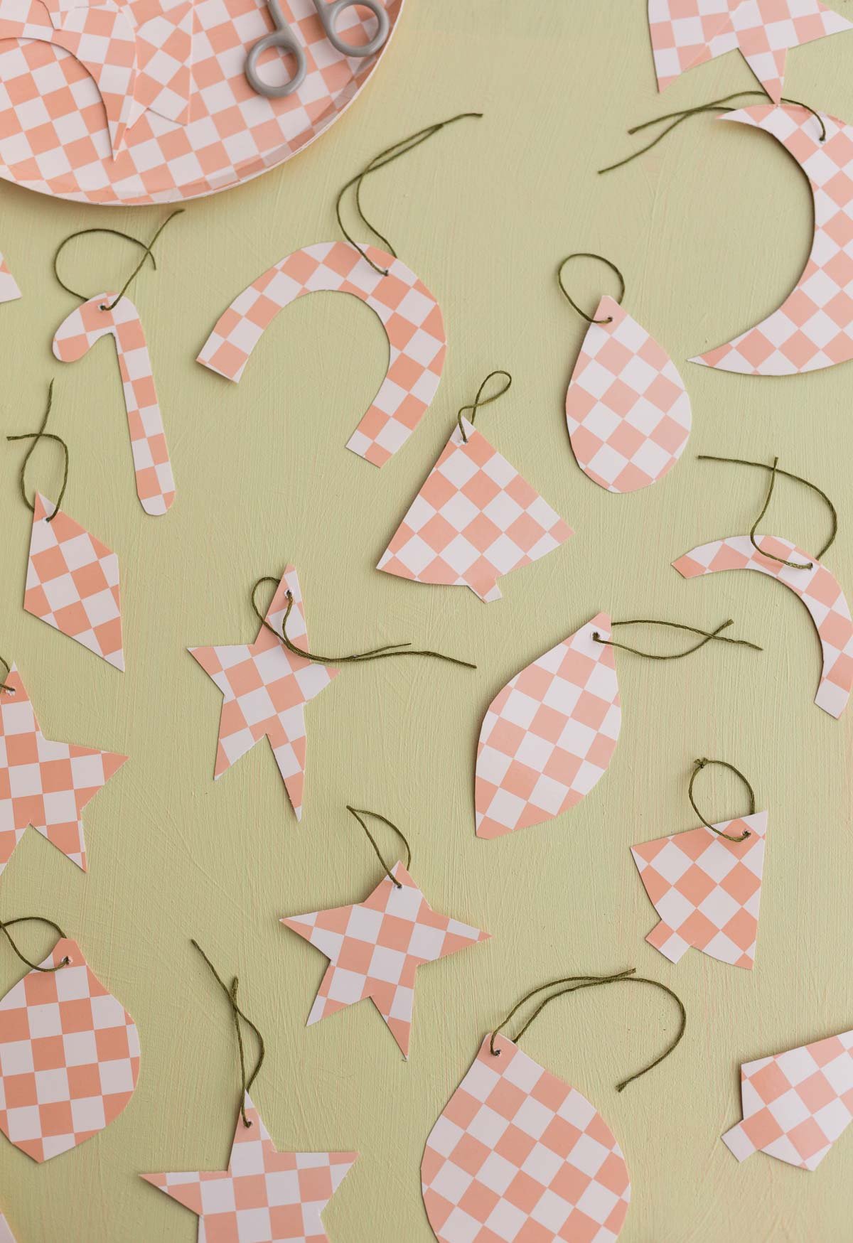 diy ornaments made from paper plates, lined up on a counter