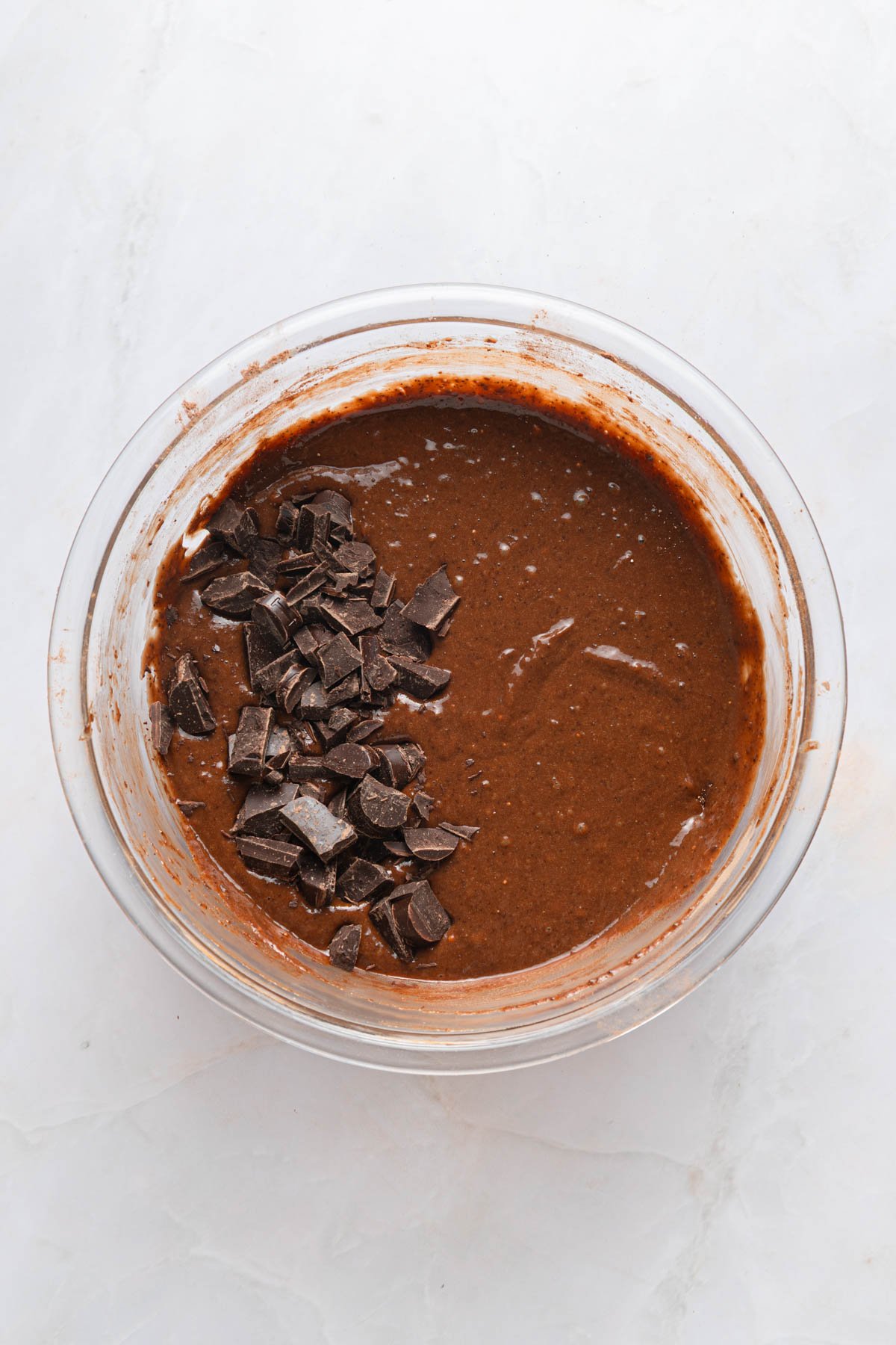 mixing brownie ingredients in a glass bowl